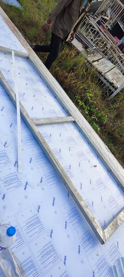 Greenhouse dryer frame component laid out over sheet material